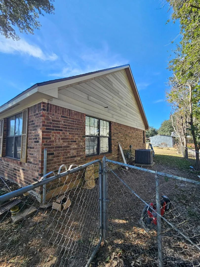 Brick home exterior with new soffit, fascia, and updated windows